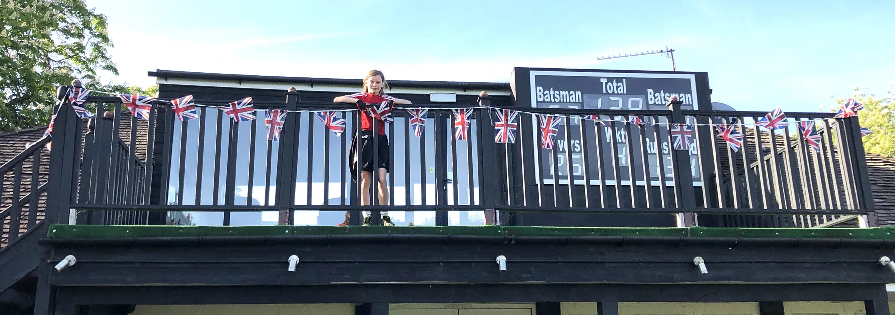 The Pavilion balcony strung with Union Jack bunting for a village celebration